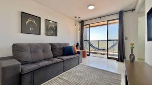 a living room with a couch and a large window at (1409) Studio Conforto Urbano com toque de Mar in Vinhais