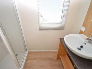 a bathroom with a sink and a shower at Coastal Comfort in Tosside +6 photos