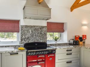 a kitchen with a red stove top oven at Lower Stables in Newlyn