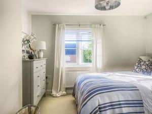a bedroom with a bed and a window at Coach House Apartment in Bournemouth