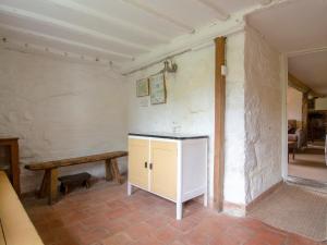 a room with a table and a bench on a wall at Avebury Cottage in Avebury +11 photos
