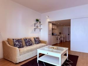 a living room with a couch and a table at Lovely Estoril Apartment in Estoril
