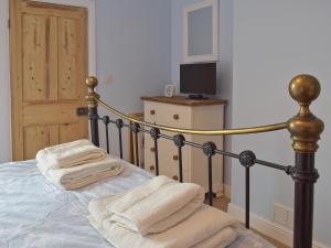 ein Schlafzimmer mit einem Bett mit Handtüchern darauf in der Unterkunft Albion Cottage in Pakefield + 6 Fotos