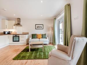 a living room with a couch and a table at Dairy Cottage-Ukc5158 in Shootend