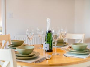 a table with glasses and a bottle of wine at Dairy Cottage-Ukc5158 in Shootend +18 photos