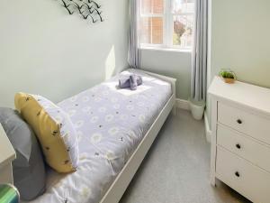 a small bedroom with a bed and a window at Low Tide - Uk50362 in Filey