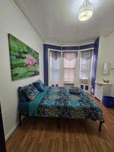 a bedroom with a bed and a window at Hudson Guest House in Jersey City