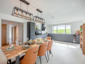 a kitchen and dining room with a wooden table and chairs at Hillside House in Berwick-Upon-Tweed +16 photos