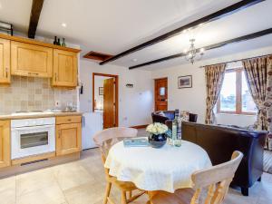 a kitchen and dining room with a table and chairs at Lintel Barn - E5253 in Runcton Holme