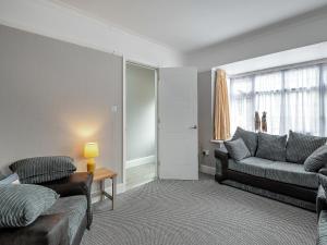 a living room with a couch and a table at Sandy Lodge in Chapel Saint Leonards