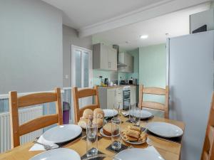 a kitchen and dining room with a table and chairs at Sandy Lodge in Chapel Saint Leonards