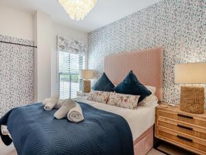 a bedroom with a bed with towels on it at Azure Bay in Woolacombe +10 photos