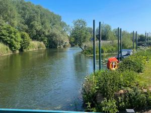 a river with a boat in the middle at Lady V in Binton