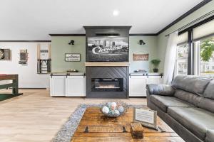 a living room with a couch and a fireplace at Luxe Suite with Pool Table, King Bed, 3 TVs, & Free Parking in Cleveland