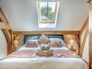 a bedroom with a large bed with a window at Y Llaethdy - Uk49916 in Penclawdd +14 photos