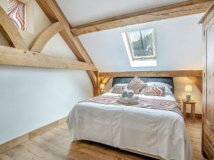 a bedroom with a large bed in a attic at Y Llaethdy - Uk49916 in Penclawdd