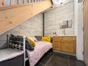 a small bedroom with a bunk bed and a sink at Fronisaf - Uk49775 in Llanfair Talhaiarn