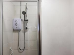 a shower with a shower head in a bathroom at Sands - Ukc6951 in Caernarfon
