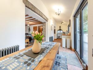 a vase of flowers on a wooden table in a living room at Shire - Uk49791 in Cribyn