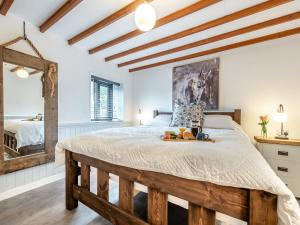 a bedroom with a bed with a tray of fruit on it at Shire - Uk49791 in Cribyn +6 photos