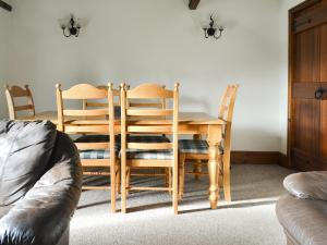 a dining room with a table and two chairs at Baileys Barn - Ukc3738 in Bawdeswell