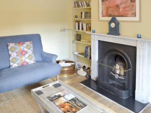 a living room with a couch and a fireplace at 33 Chapel Street in Penzance