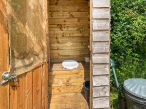 a wooden outhouse with a toilet in it at Water Vole - Uk49931 in Shadoxhurst +3 photos