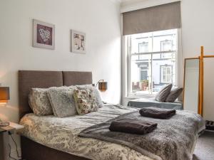 a bedroom with a bed with pillows and a window at Headland View in Scarborough