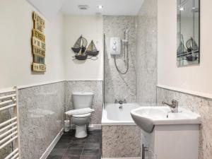 a bathroom with a sink and a toilet and a shower at Headland View in Scarborough