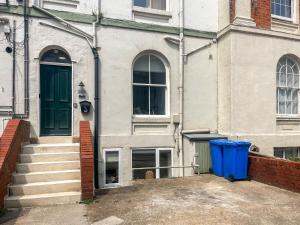 a building with a blue trash can in front of it at Headland View in Scarborough +4 photos