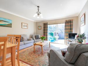 a living room with a couch and a table at Tummel Bank in Pitlochry