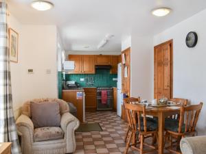 a kitchen and dining room with a table and chairs at Dairy Cottage - Uk49834 in Lanivet