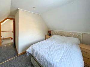 a small bedroom with a bed and a closet at Seaside in Peacehaven
