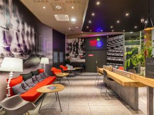 a lobby with a couch and chairs and tables at ibis Warszawa Centrum in Warsaw