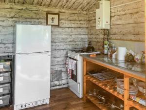a kitchen with a white refrigerator and a stove at Sweet Briar - Uk49797 in Brecon