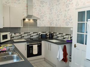a kitchen with a sink and a stove top oven at High Bank in Bunbury