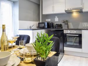 a kitchen with a table with chairs and a dining room at Apartment 3 - Uk50137 in Stoke on Trent