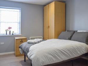 a bedroom with a large bed and a yellow cabinet at Apartment 3 - Uk50137 in Stoke on Trent
