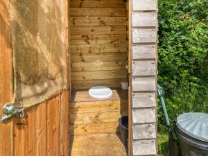 a wooden outhouse with a toilet in it at Barn Owl - Uk49932 in Shadoxhurst