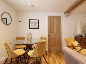 a dining room with a table and chairs at The Cottage in Malmesbury