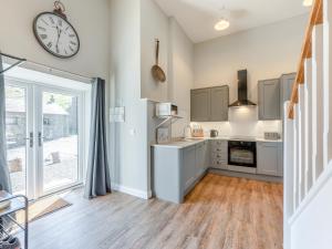 a kitchen with a large clock on the wall at Tower Cottage in Glenridding