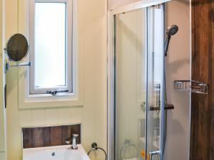 a bathroom with a sink and a shower with a window at Chestnut - Ukc4848 in Cantley +3 photos