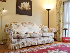 a living room with a couch with pillows on it at Draig's Cottage in Abergavenny