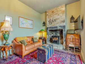 a living room with a couch and a fireplace at Greystonedale Mansion Holiday Retreat in Haltwhistle