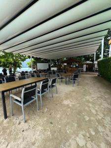 a group of tables and chairs under a large umbrella at Beachside Bliss in Ban Saiyuan (1)