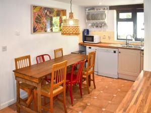 a kitchen with a wooden table and chairs at Townwood House in Tiverton