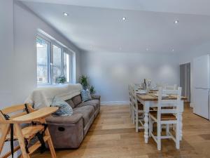 a living room with a couch and a table at Spring Gardens in New Quay