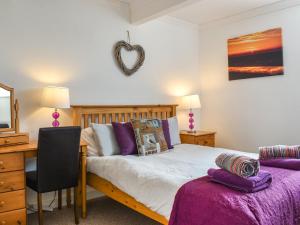 a bedroom with a bed and a desk with a mirror at Denelea - Uk49954 in Scarborough