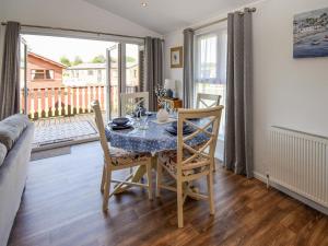 a dining room with a table and chairs and a balcony at Sunnybank in Warton