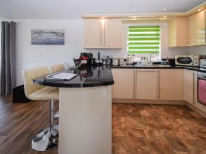 a kitchen with a black counter top in a room at Sunnybank in Warton +9 photos